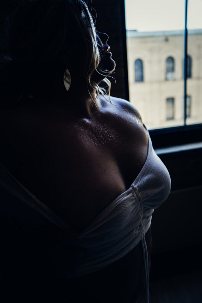 silhouette of a woman in a wet tshirt  her lips are highlighted