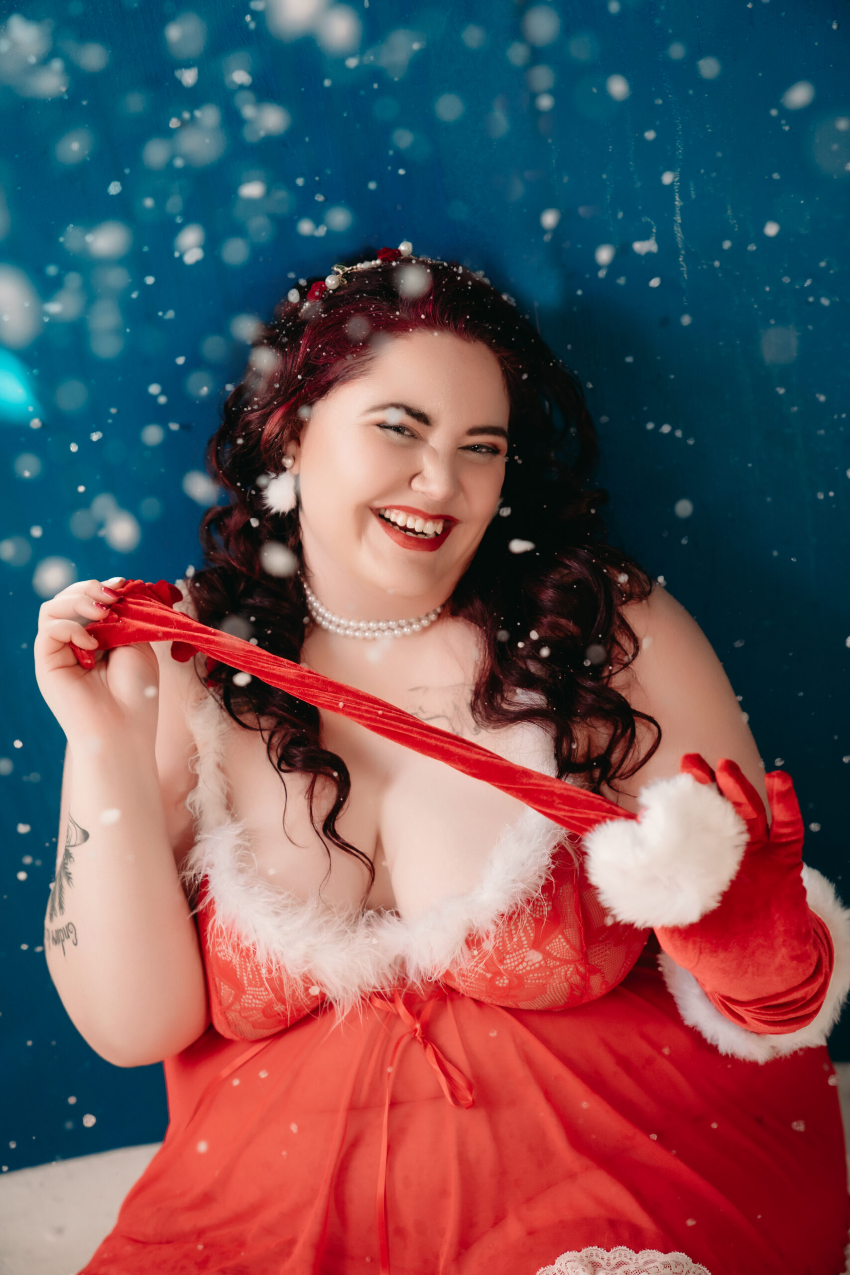 Christas red lingerie with red gloves and white fur in the snow